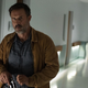 Dewey walking with a gun.